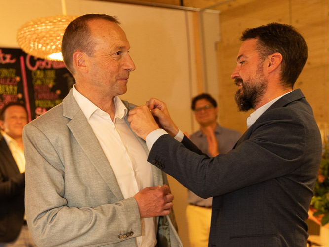 Foto von der Amtsübergabe: Dr. Florian Kiefer (r.) übergibt die Präsidentennadel an Andreas Voigt.